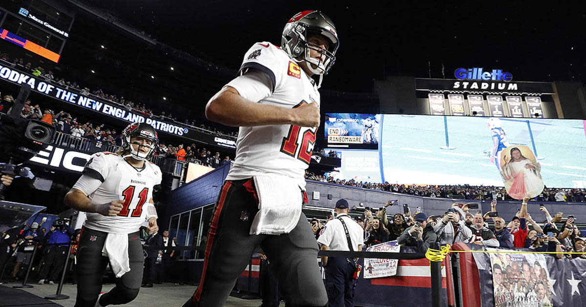 Brady runs out of the tunnel in his return to Gillette Stadium with the Buccaneers in 2021.